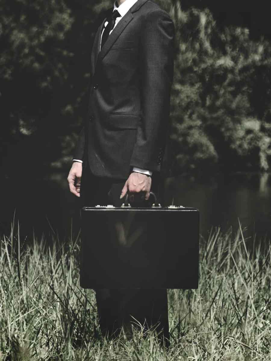 businessman standing grass outdoors scaled 1