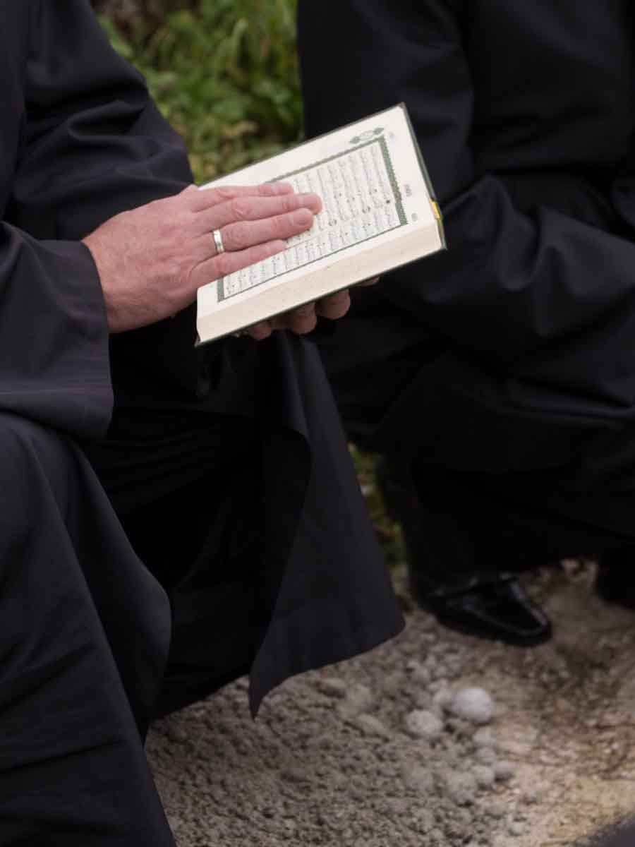 quran-holy-book-reading-by-imam-islamic-funeral-with-white-thumb-stones-graweyard-background-scaled